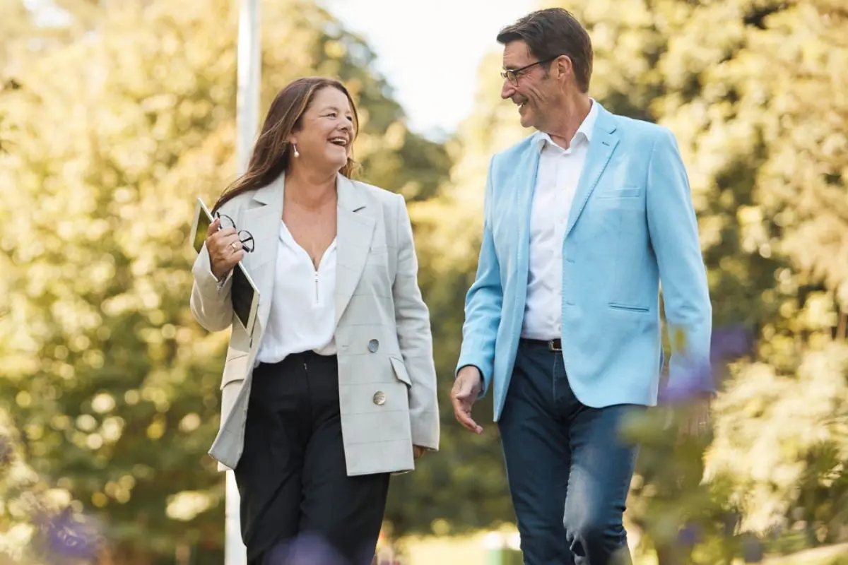Sarah and Mike walking through leafy suburb Northern Beaches property buyer lifestyle.