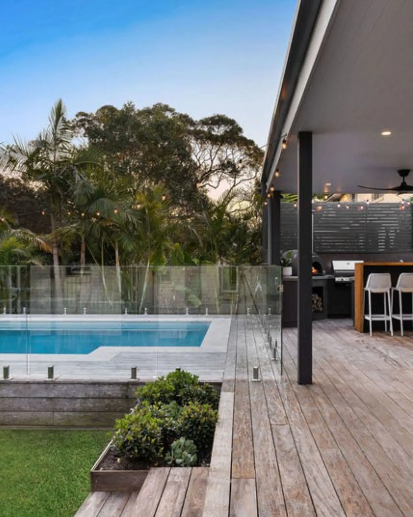 Private backyard oasis featuring a modern swimming pool and timber decking, an example of the premium features we seek in family homes