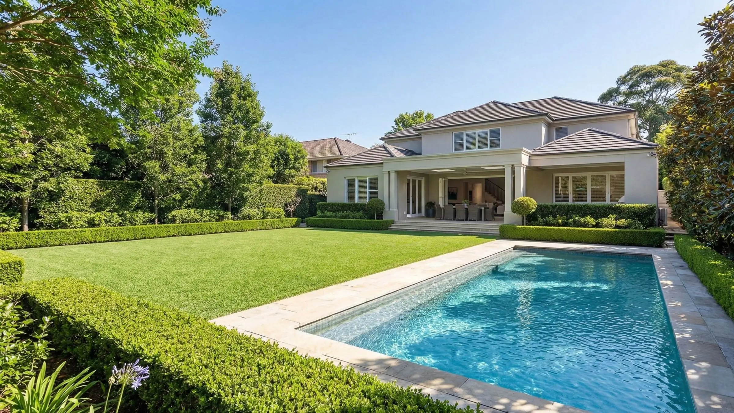 Manicured backyard with swimming pool and level lawn at a luxury family estate on the Upper North Shore