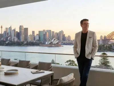 Principal of Sarah Kaye & Co on a private balcony with Sydney Harbour views, embodying director-led strategic advocacy