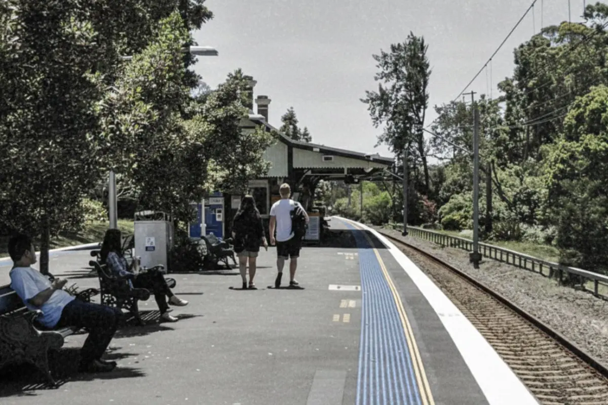 A cinematic view of Wahroonga Train Station on Sydney’s Upper North Shore, processed with a professional grade consistent with Sarah Kaye & Co’s editorial aesthetic. This image accompanies a strategic market analysis of Wahroonga property trends for elite buyer’s agent clients seeking lifestyle connectivity.