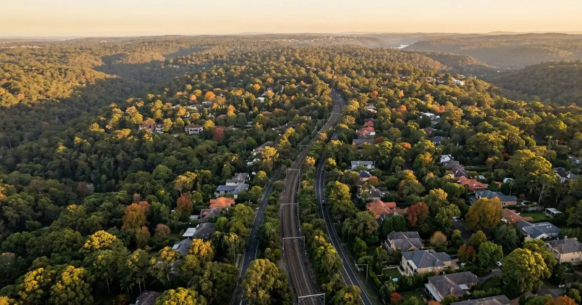 upper-north-shore-property-prices-aerial-lindfield-to-wahroonga Aerial view of Sydney's Upper North Shore between Lindfield and Wahroonga, showing the leafy tree canopy that defines the established family-home corridor