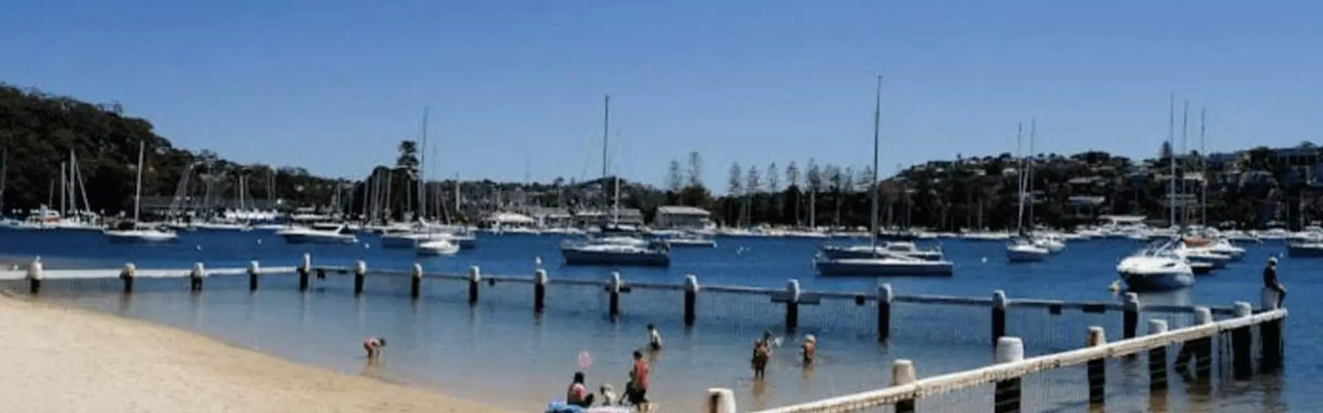 Clontarf Beach and its netted swimming area on Middle Harbour