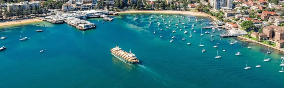 Manly Cove and Manly Wharf from the air, with a ferry coming in