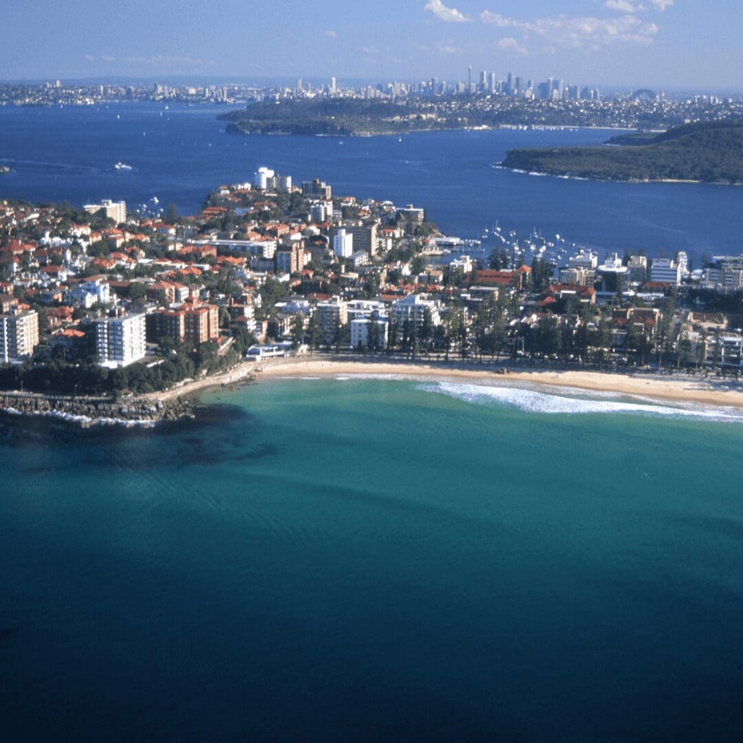 Eastern aerial of Manly showing surf, homes, and beaches – key view for any Manly buyers agent.